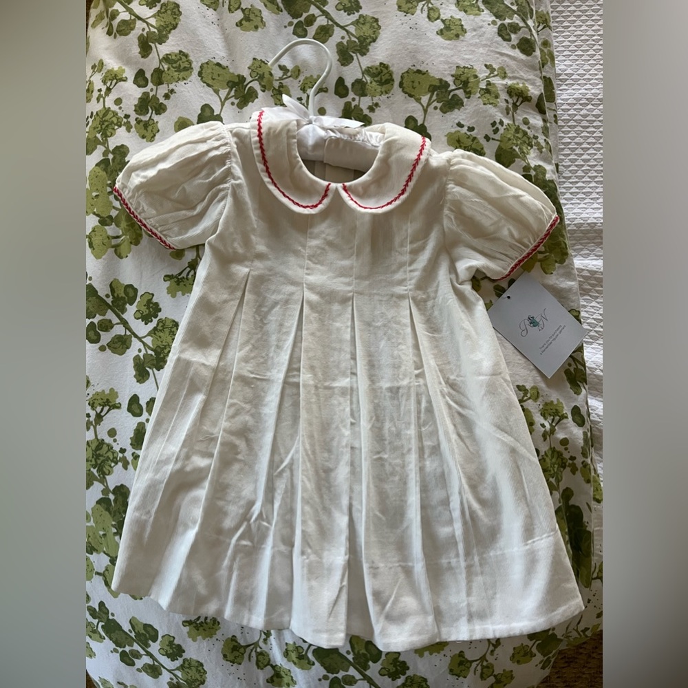 Never worn white corduroy dress with red trim remember nguyen